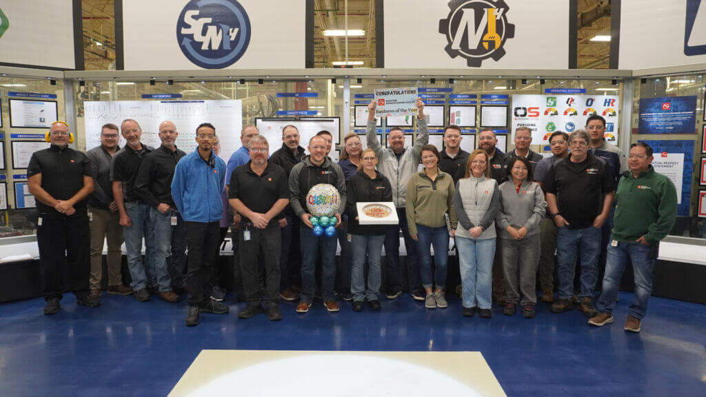 AAM employees standing together to celebrate winning Wells County Chamber's Business of the Year for 2026.