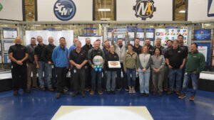 AAM employees standing together to celebrate winning Wells County Chamber's Business of the Year for 2026.