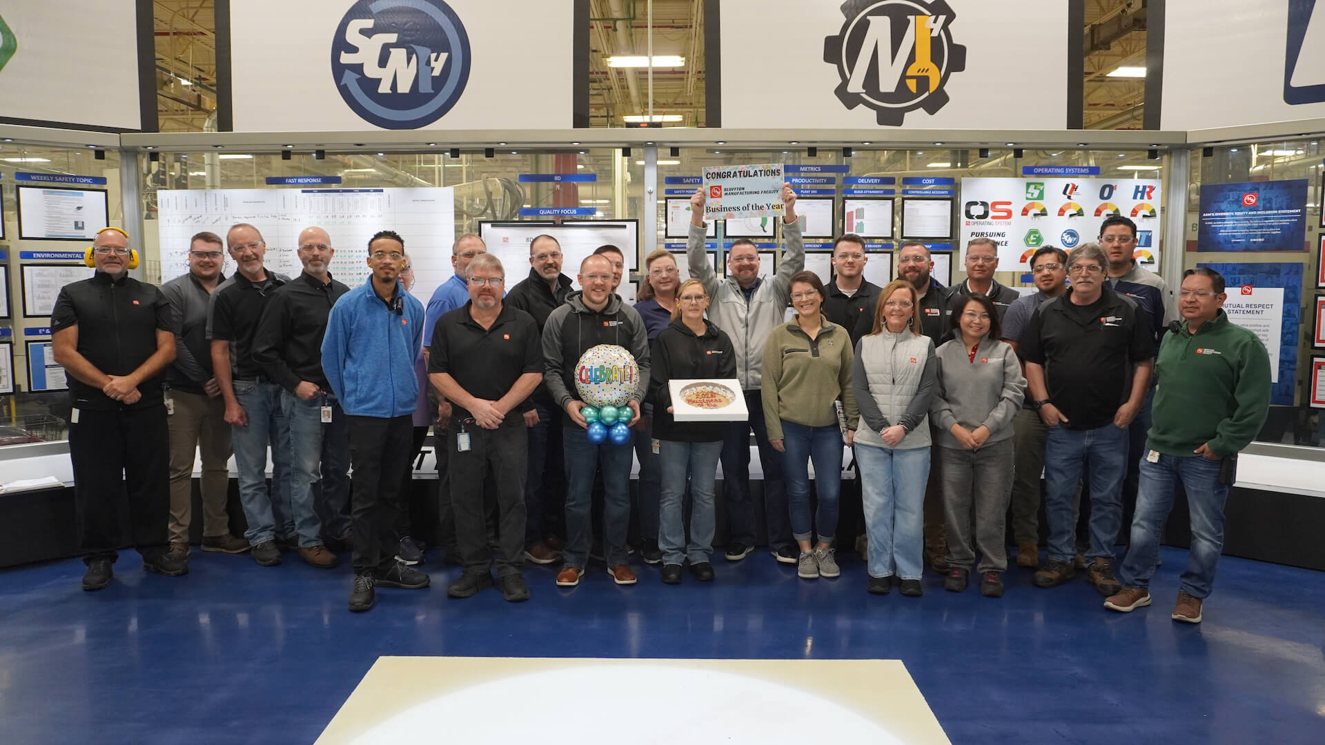 AAM_BusinessOfTheYear2026 AAM employees standing together to celebrate winning Wells County Chamber's Business of the Year for 2026.