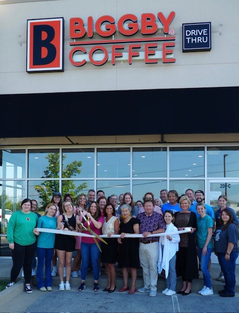 Cari Cousins, owners, cuts the ribbon celebrating BIGGBY Coffee's Opening