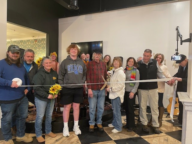 rish Torline cuts the ribbon celebrating Heartstrings Songwriters Circle membership into the Winchester-Clark County Chamber of Commerce.