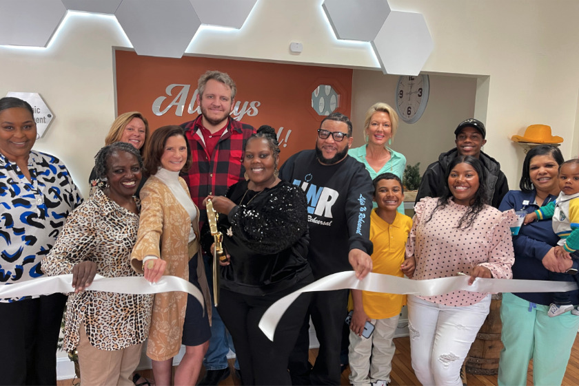 Chlandra Chenault cuts the ribbon celebrating Designs & More membership into the Winchester-Clark County Chamber of Commerce.