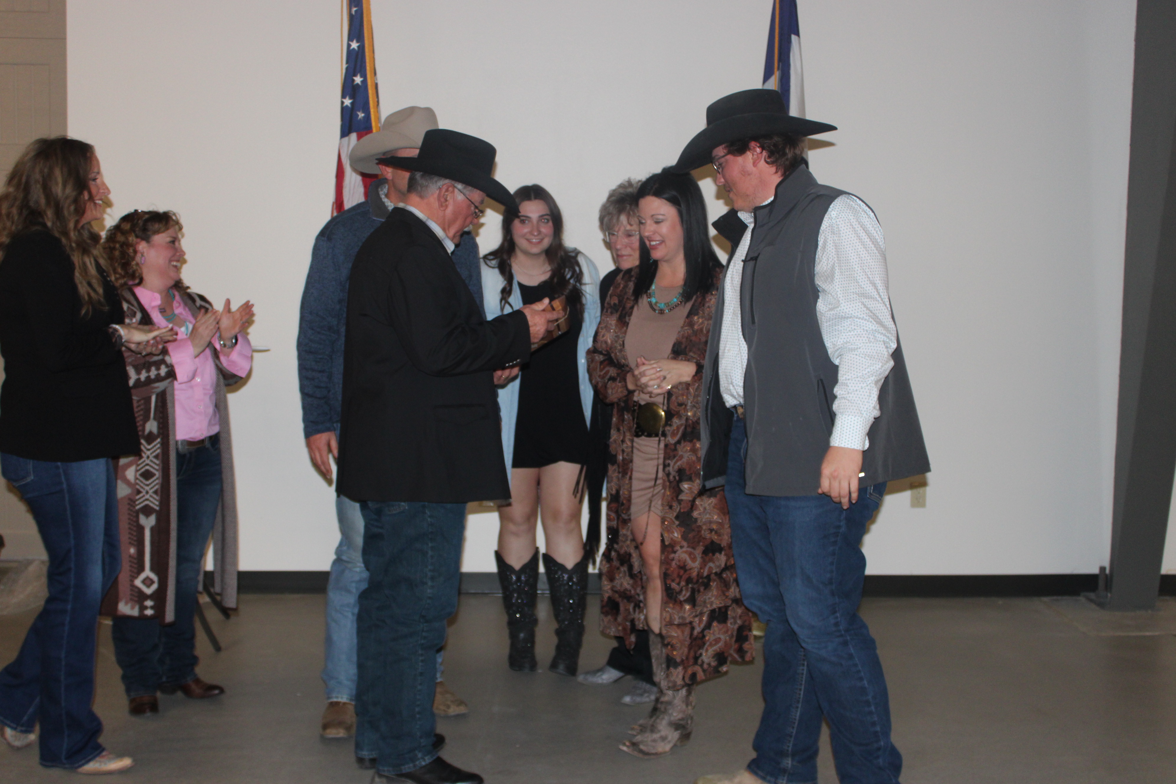 The Jim and Becky Santomaso family accept the Business of the Year Award given to them by Caitlin Baseggio, executive director of the Logan County Chamber of Commerce, and Melanie Buckler, 2024 Chamber board president, at the Chamber's "Hometown Proud: Return to Rural" Banquet and Awards Friday, Jan. 24, 2025. (Callie Jones/Journal-Advocate)