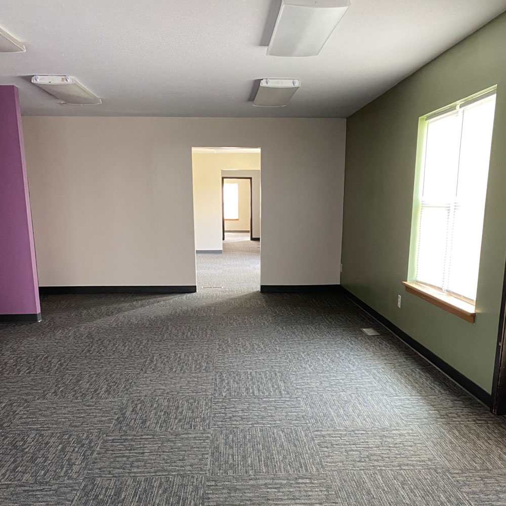colorful office space with large window.