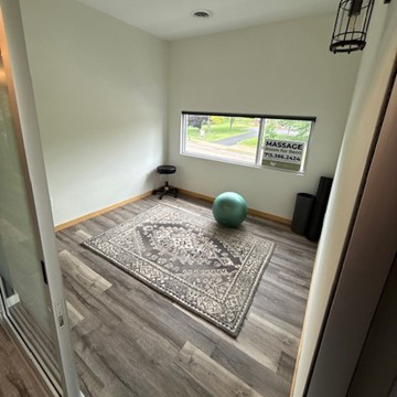 open room with hardwood floors and large window.