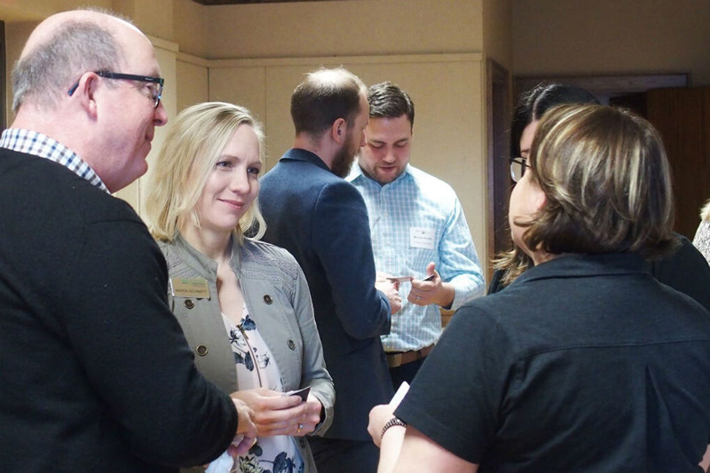 Chamber members socializing in small groups.