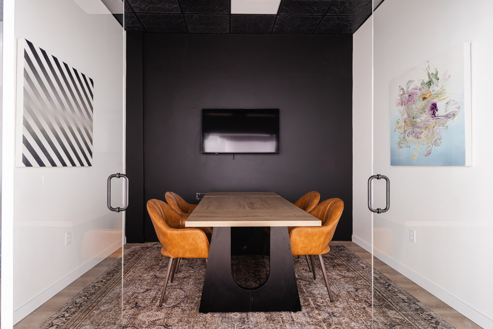 meeting space with chairs, table, and monitor.