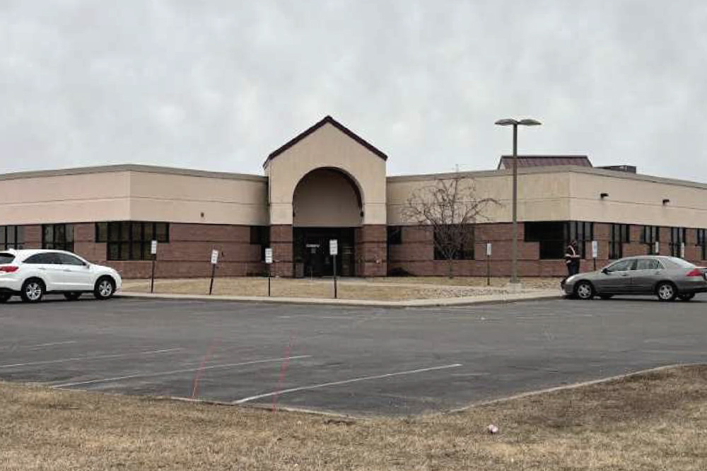 Exterior of office building with parking lot.
