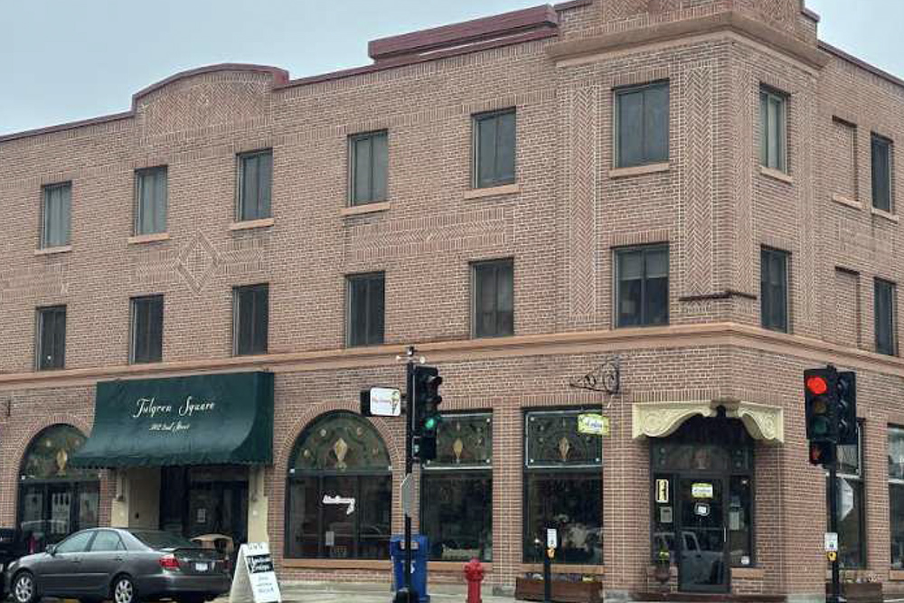 Exterior of multilevel brick building with historic features.