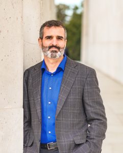 Michael Bamdad headshot, man with royal blue dress shirt, and gray suit