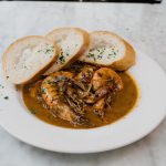 Mr. B&#039;s Bistro, New Orleans Restaurant, bowl of shrimp dish with three pieces of bread around rim.