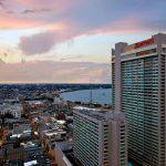 Photo of New Orleans Marriott&#039;s two towers, exterior view at sunset and Mississippi River and other downtown buildings in background.