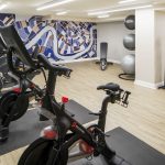 New Orleans Marriott photo inside the Fitness Center. Photo shows Peloton Bikes, Matrix machines, and balance balls.