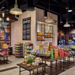 Interior of New Orleans Marriott&#039;s Canal Street Pantry. Photo shows multiple display tables, racks and shelves of individually packaged food items, fruit, and snacks.