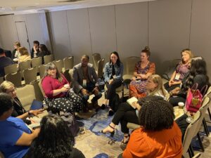 Small group of people sitting in a circle in a meeting room