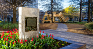 Entrance to Woodruff Park in Atlanta with red tulips and ATL abstract artwork