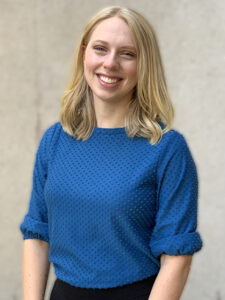 Stephanie Fowler-Brookman headshot, woman with blonde, shoulder-length hair, wearing a royal blue blouse and black pants.