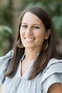 Missy Curtis headshot, white female, long brown hair, light blue blouse