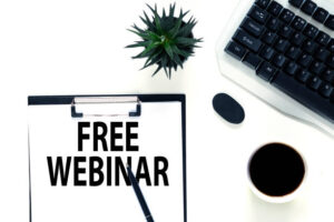 Free Webinar Notebook with an free webinar and sticker today on white desk with cup of coffee. Business concept.