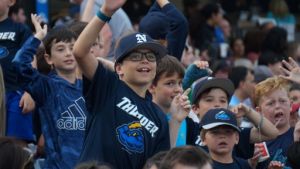 kid in the crowd wearing a thunder shirt