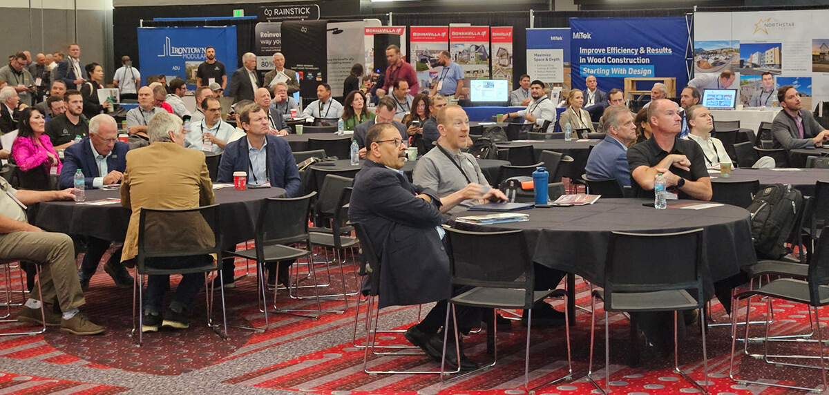 Attendees look on as Summit presenters take the stage.