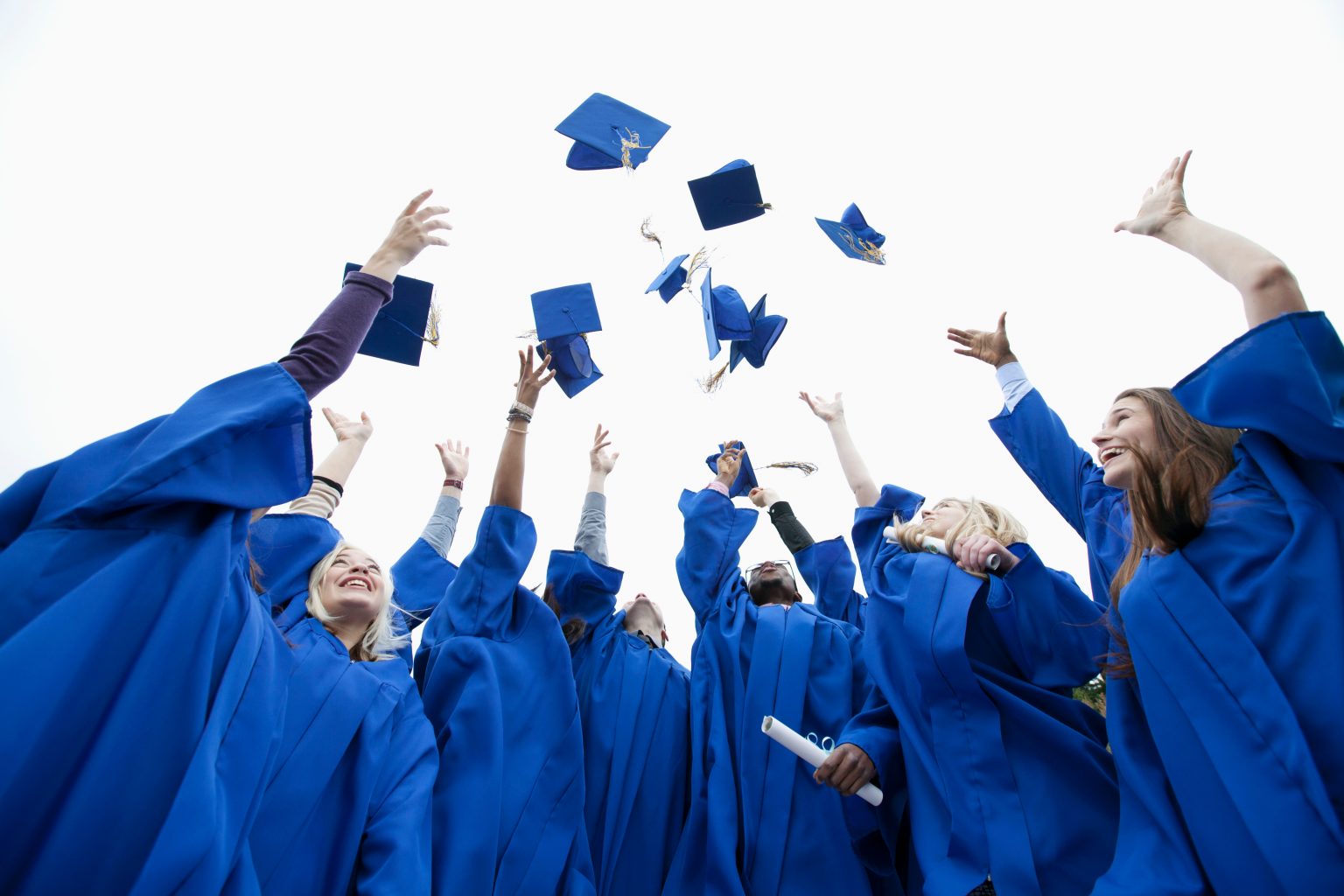 Graduate throwing caps in the air