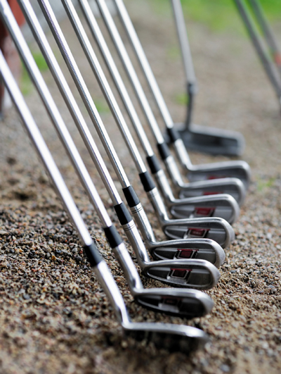 picture of golf clubs stacked in a row
