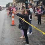 These girls brought their own flags for the National Anthem.