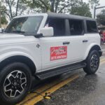 Grand Marshal riding in style in a Stanley Ford Bronco!