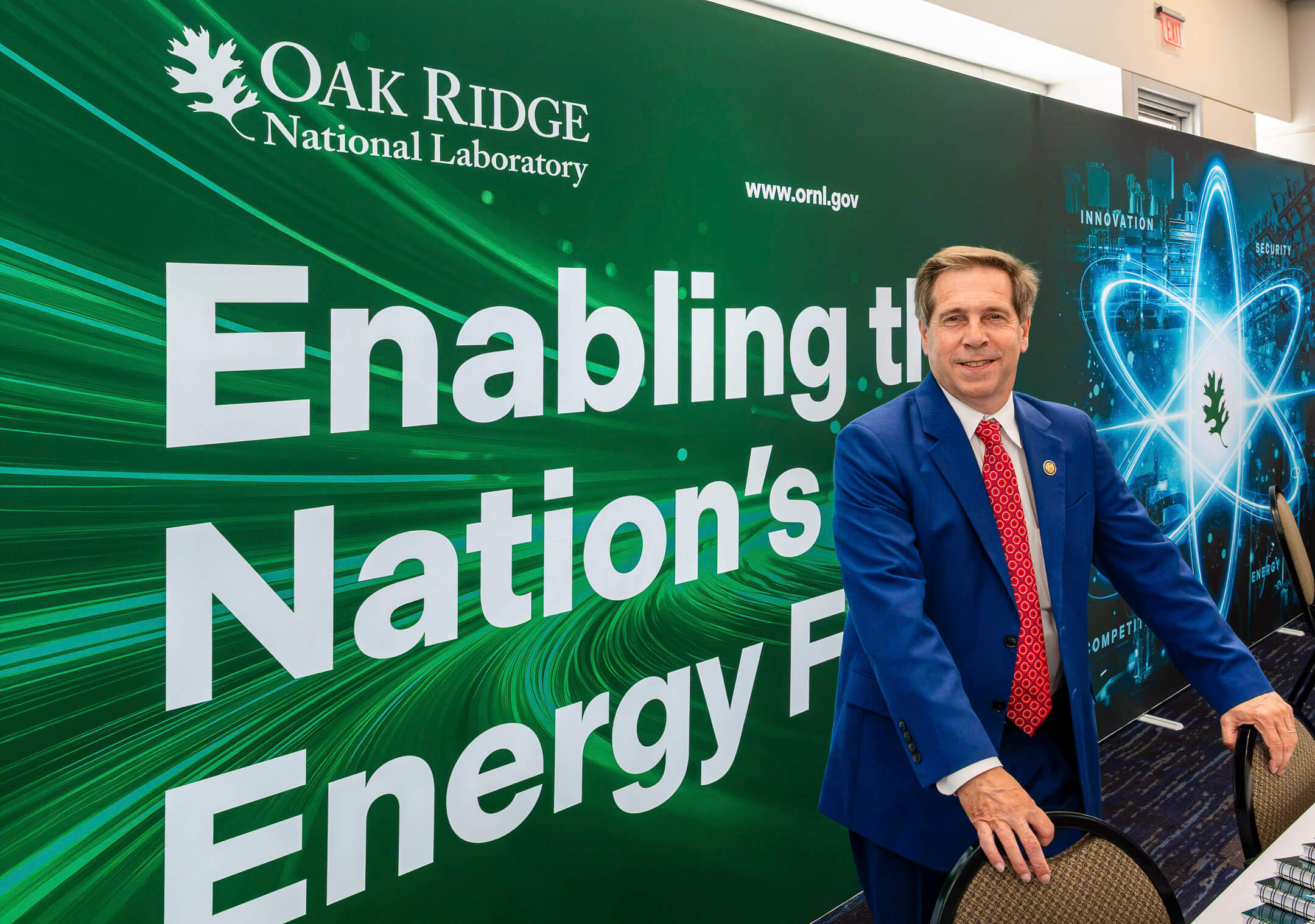 26_P000810 U.S. Rep. Chuck Fleischmann poses in front of the Oak Ridge National Laboratory booth during the NOW Conference at the Knoxville Convention Center in Knoxville, Tennessee, on Tuesday, Aug. 4, 2026. The conference brings together leaders from government, national laboratories, industry and academia to advance collaboration on nuclear technologies that strengthen U.S. energy security, innovation and economic competitiveness.