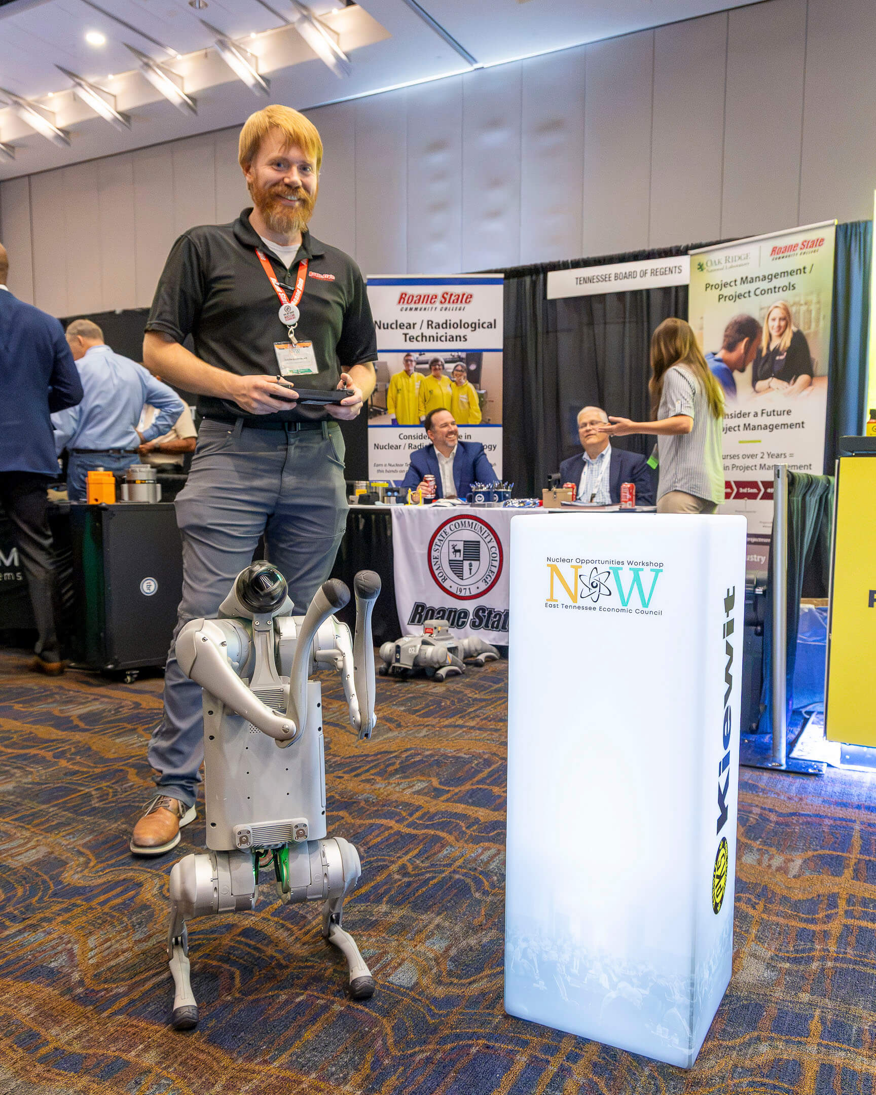 26_P000810 Knoxville, Tenn., Wednesday, Aug. 5, 2026 — Justin Eisenhauer, right, of Roane State Community College demonstrates the college’s robotic quadruped during the Nuclear Opportunities Workshop (NOW) Conference at the Knoxville Convention Center. The interactive exhibit showcases robotics and emerging technologies that are helping prepare the next generation of the nuclear workforce while highlighting innovative tools supporting the industry's future.
