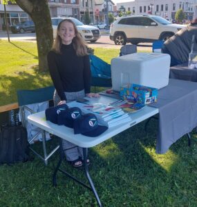 WAVE Member Lexi Hagen, with MBDC - Present at the City of Menominee's Activity Booth (2025 CITP Moovin' Sponsor) at Daizy Roots Band Concert in the Park