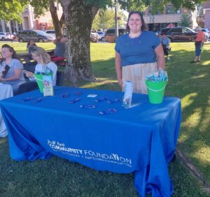 WAVE Member Kaitlin Deschane - Representative at M&M Area Community Foundations Activity Booth (2025 CITP Rockin' Title Sponsor) at Daizy Roots Band Concert in the Park