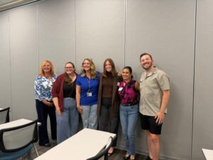 June 2026 - Some of the WAVE members (three are pictured on the right and one mid-left), not just supporting, but presenting and facilitating Intern Onboarding Day! 