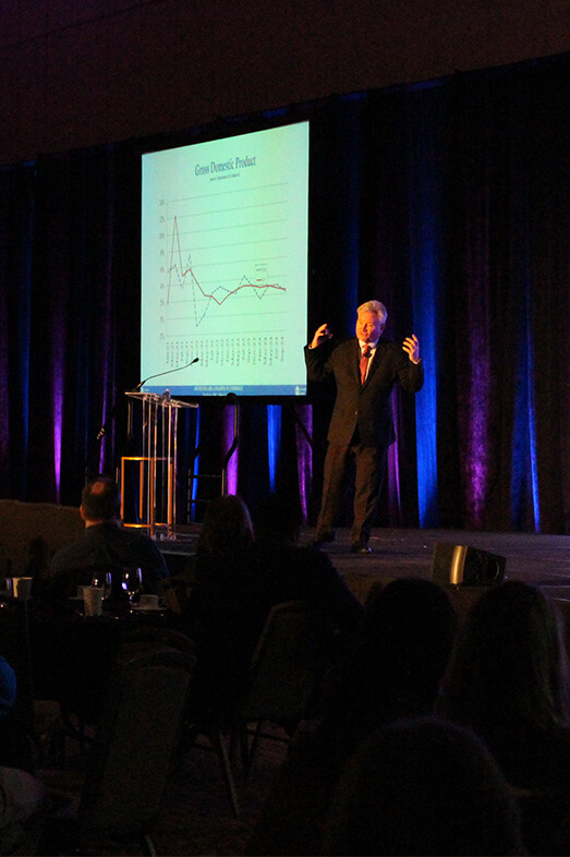 Keynote speaker on stage at Economic Summit