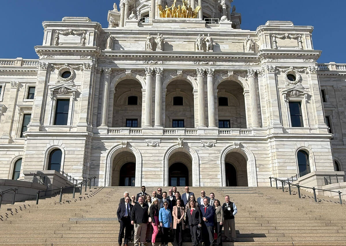 Group photo of attendees in front of the MN Capitol building
