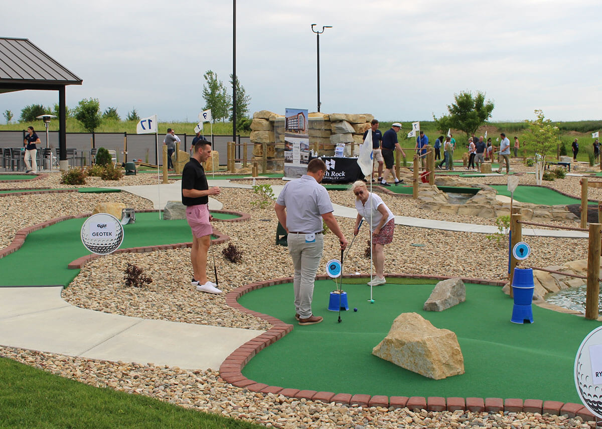 Team playing mini golf