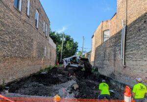 Construction activity on vacant land at Berwyn Art Park, featuring a crew and various construction tools and equipment.