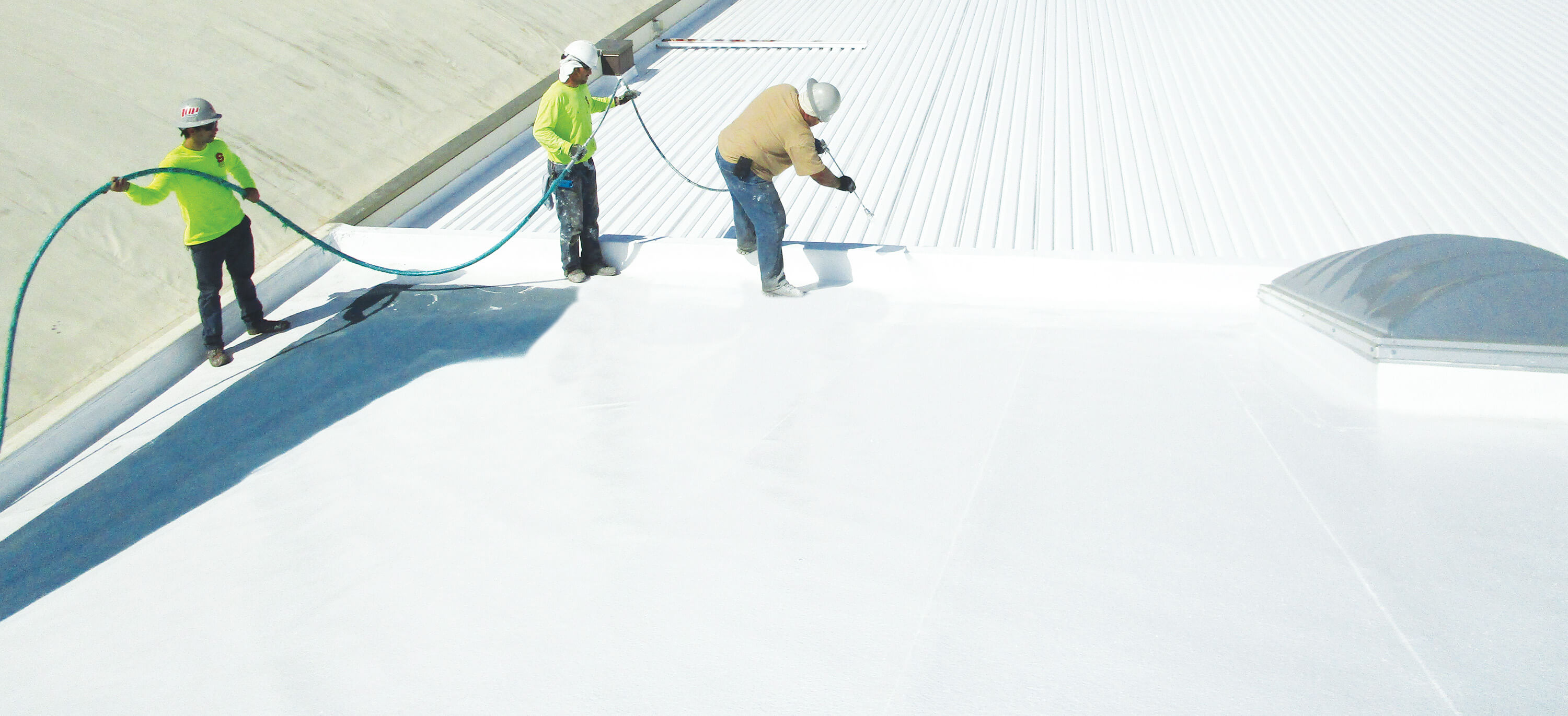 men spraying roof