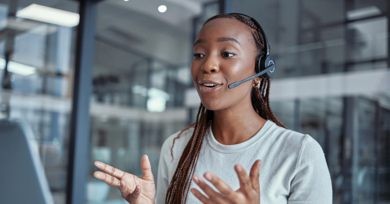 Lively Telemarketing Conversation Woman with headset speaking and gesturing.