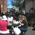 People eating in an Alley