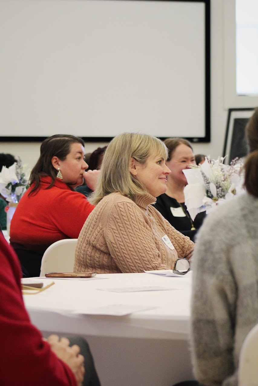 Melissa Conley with First National Bank listens as 2026 programming announcements are made.