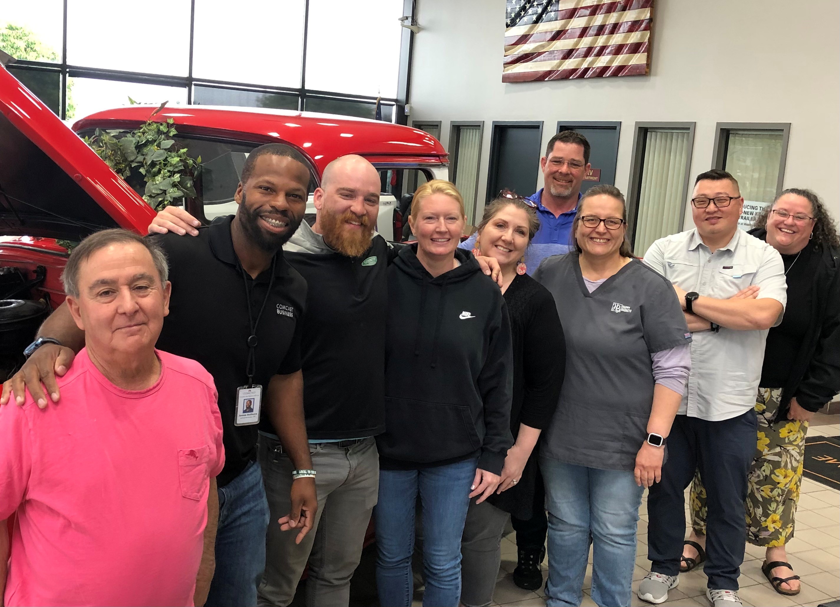 2025-06-01 Team at Weston Photo of people smiling in front of red vintage truck