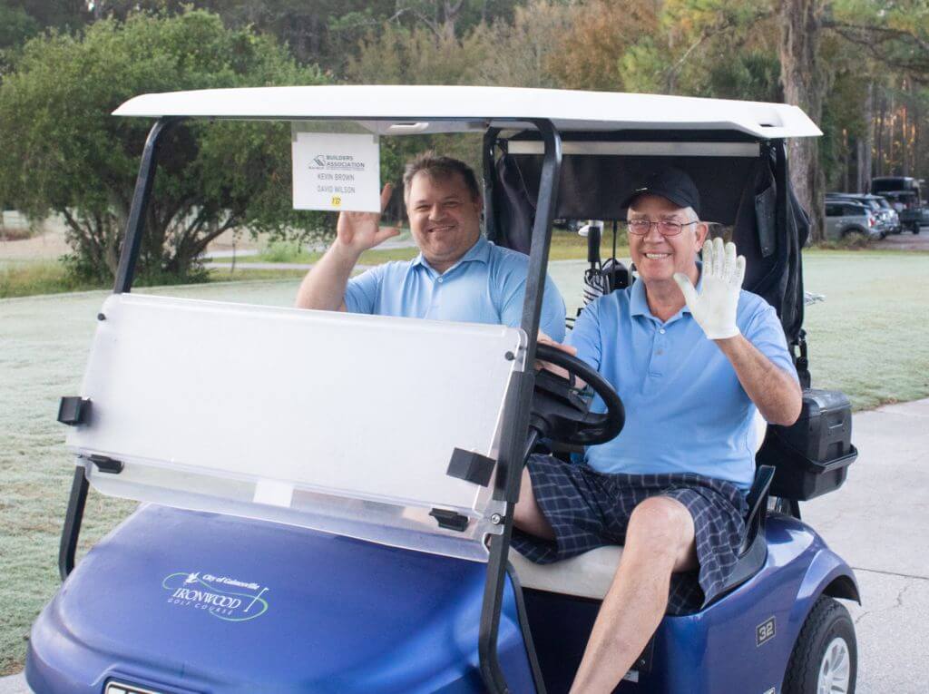 2 men in a golf cart