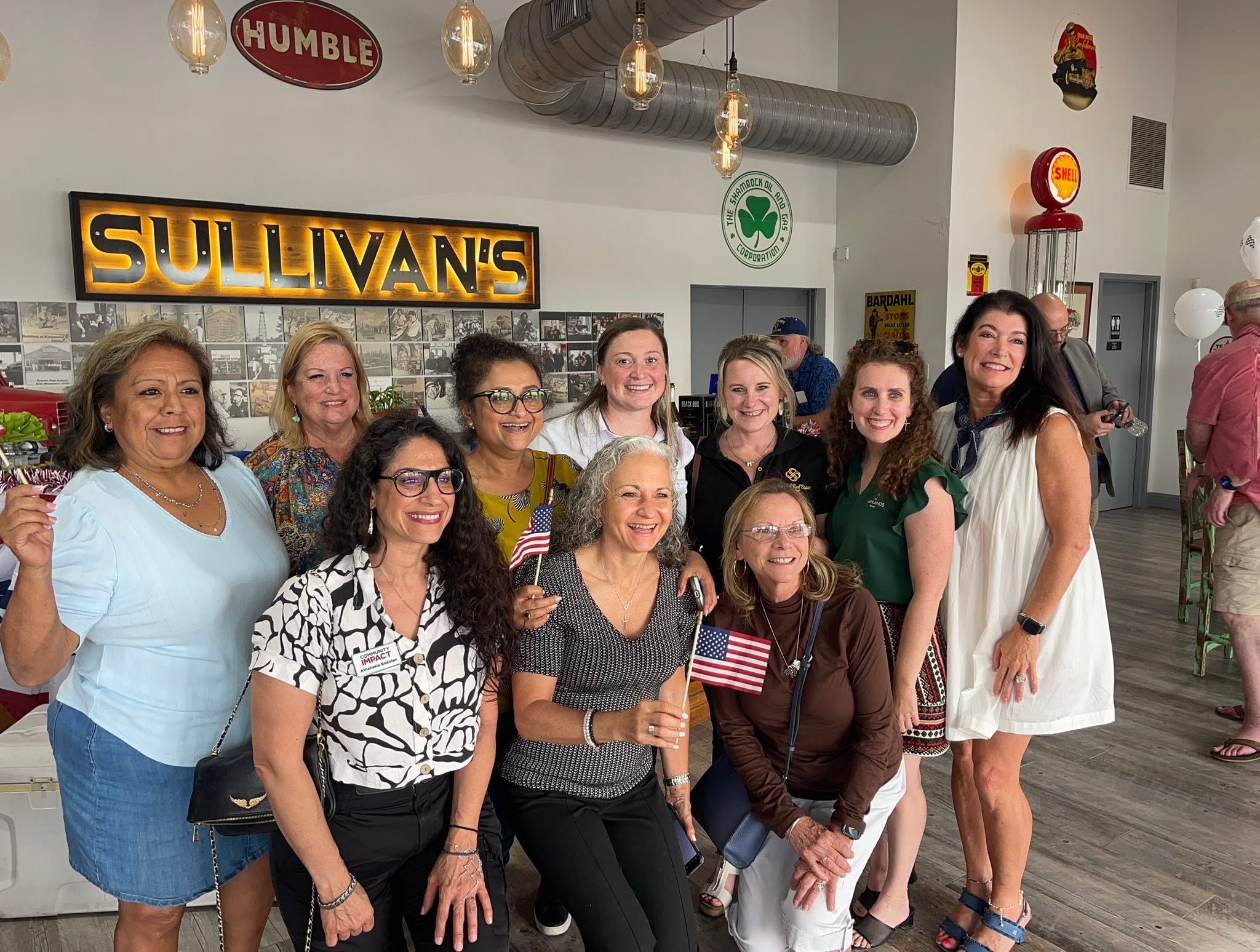 Kelly Sullivan McGriff proudly stands among community members and Chamber members who support Sullivan’s through the Pit Stop Pop In.