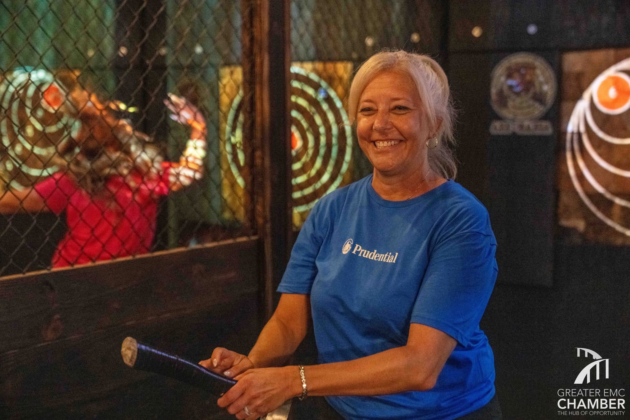 07_Prudentialteam A member of the Prudential Financial Advisors – David Harris axe-throwing team shares her enthusiasm during the tournament