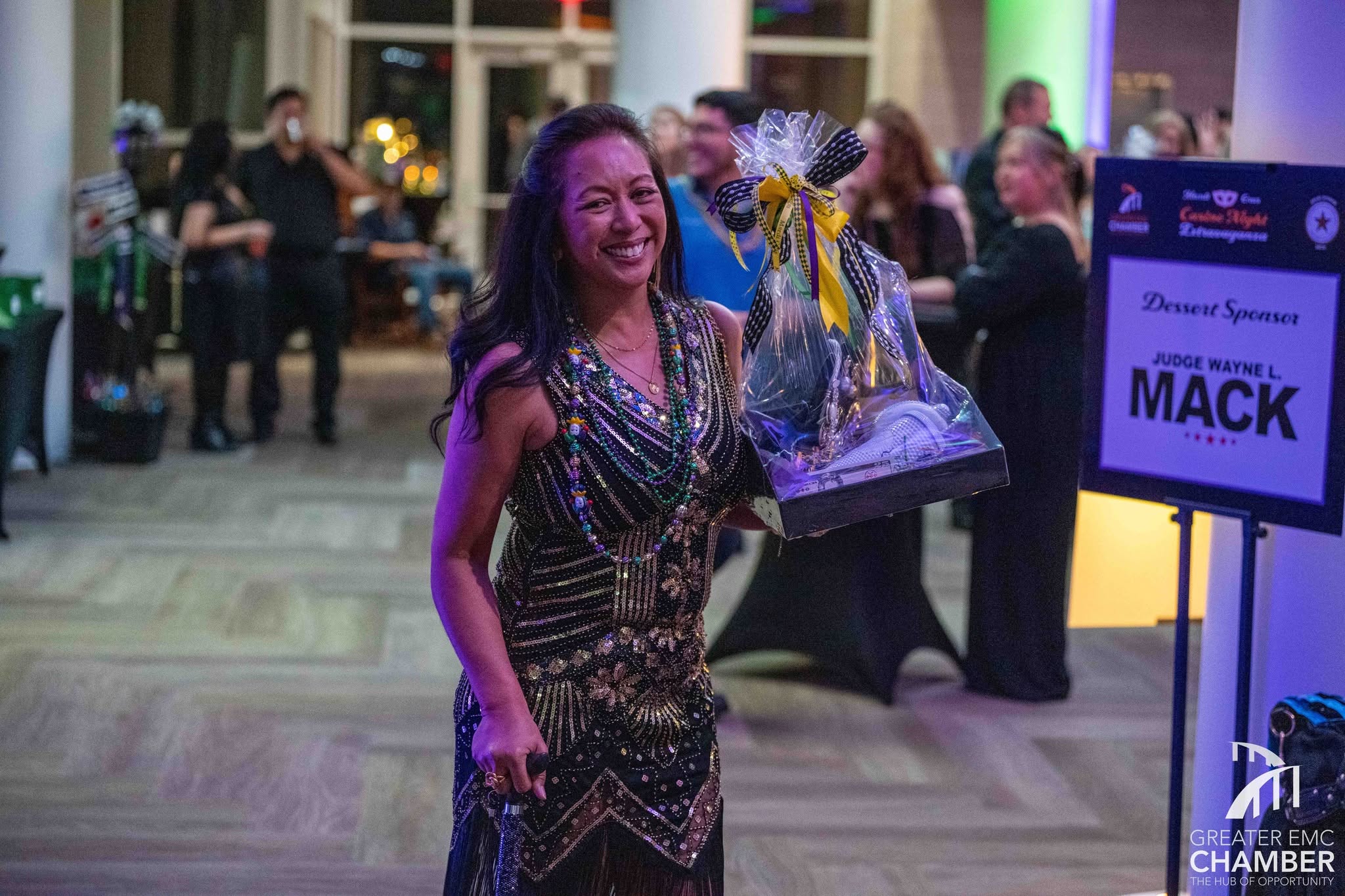 Casino Night Winning Evelyn is seen here at the 2026 Mardi Gras Casino Night after claiming one of the three raffle baskets she won that night.