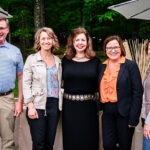 Three business women and one man posing