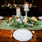 Formal place setting with candles and flower centerpiece