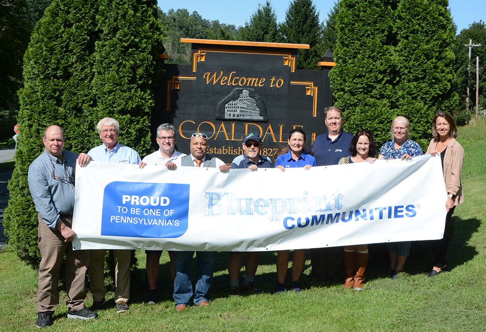 Coaldale Group holding Blueprint Communities banner